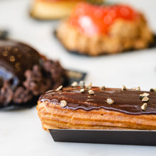 Load image into Gallery viewer, assorted cake, including a chocolate eclair
