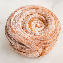 Load image into Gallery viewer, a morning bun made of swirling croissant dough and rolled in cinnamon sugar. 
