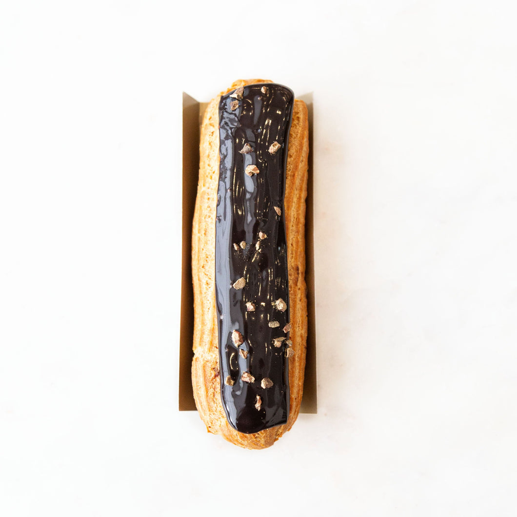 chocolate eclair with golden cocoa grue on top